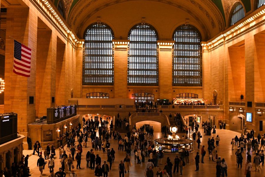 Grand Central's Main Concourse under its arched windows and flag