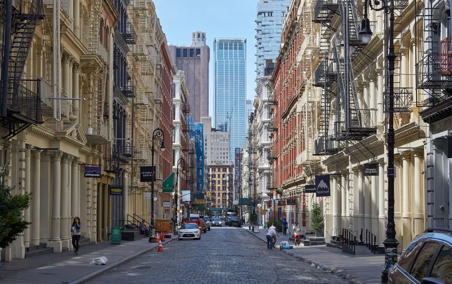 Cast-iron facades and fire escapes receding along Greene Street in SoHo