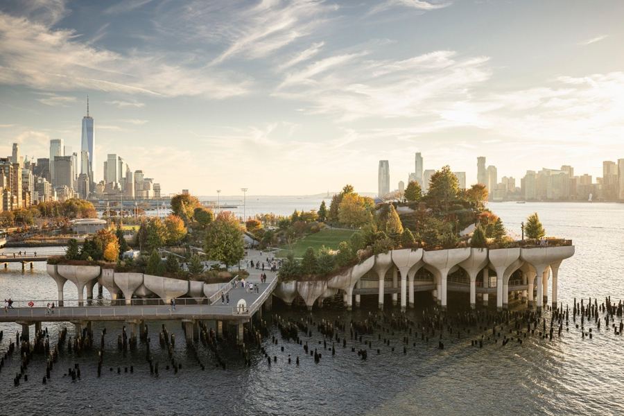 Little Island's tulip-shaped piles and planted hills on the Hudson, Lower Manhattan beyond