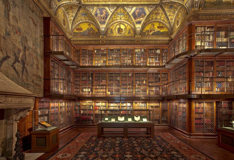 The East Room of J. P. Morgan's library: three tiers of walnut bookcases rising to a painted, gilded ceiling