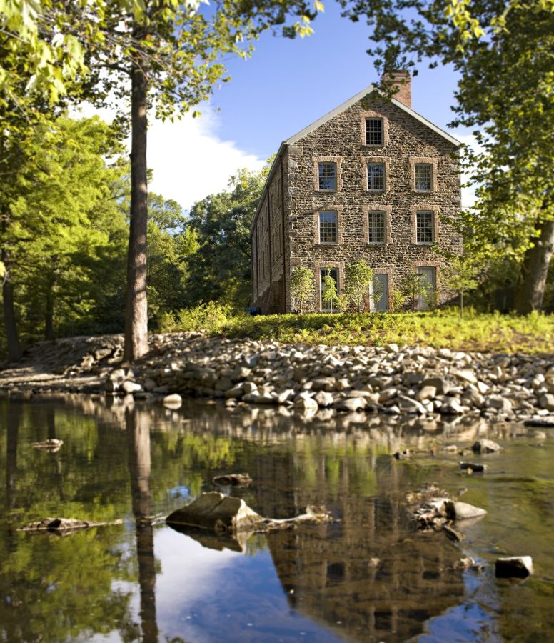 The 1840 Stone Mill on the Bronx River, reflected in the water