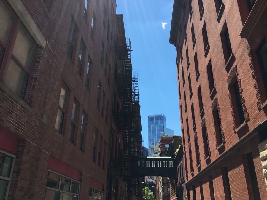 The small enclosed skybridge spanning narrow Staple Street between brick buildings in Tribeca