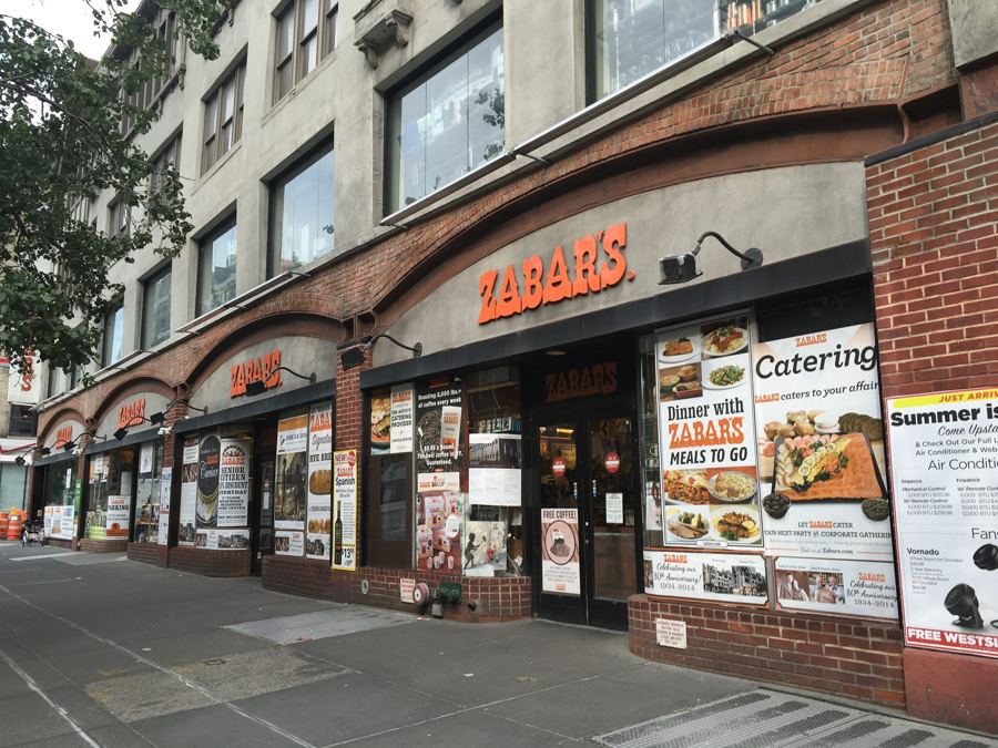 Zabar's storefront with its orange signage and awnings on Broadway at West 80th Street