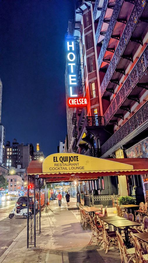 The Hotel Chelsea's neon sign at night above El Quijote on West 23rd Street