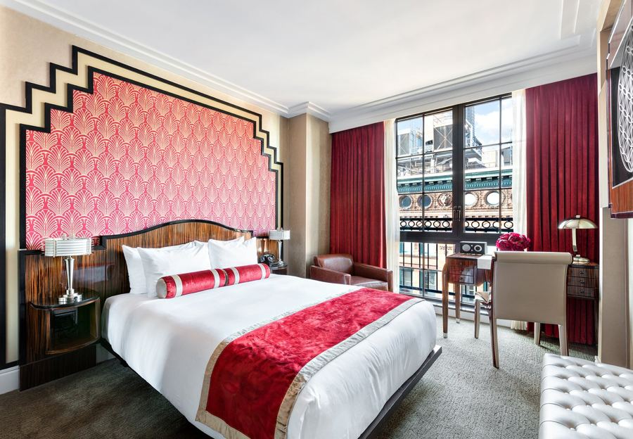 A Grove guest room with a red Art Deco headboard at Walker Hotel Greenwich Village