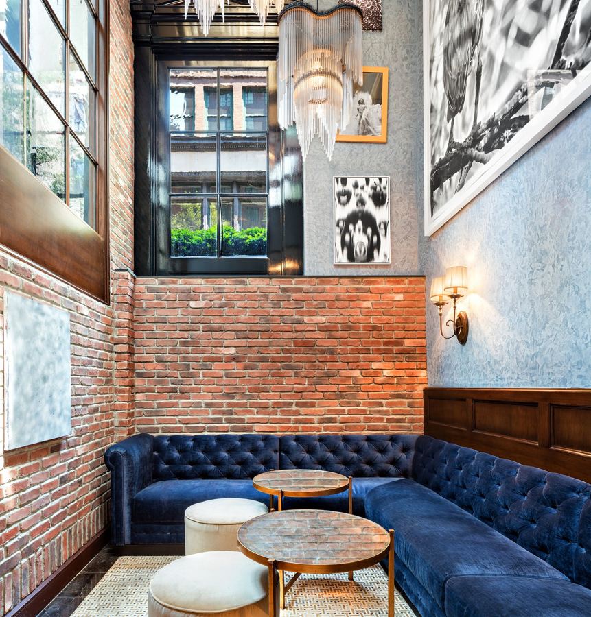 A blue velvet banquette in the lobby alcove at Walker Hotel Greenwich Village