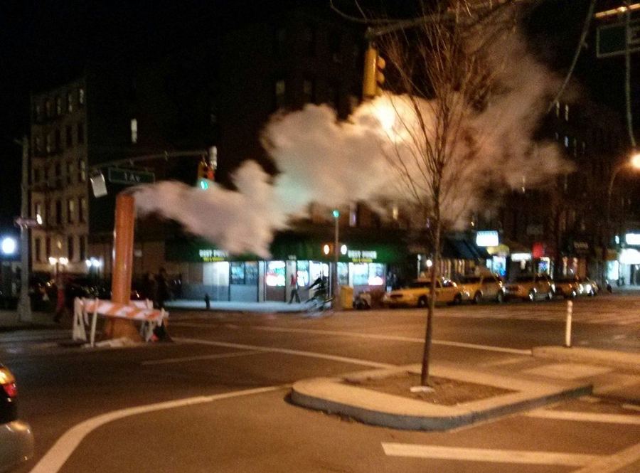 Steam rising from a Manhattan street at night