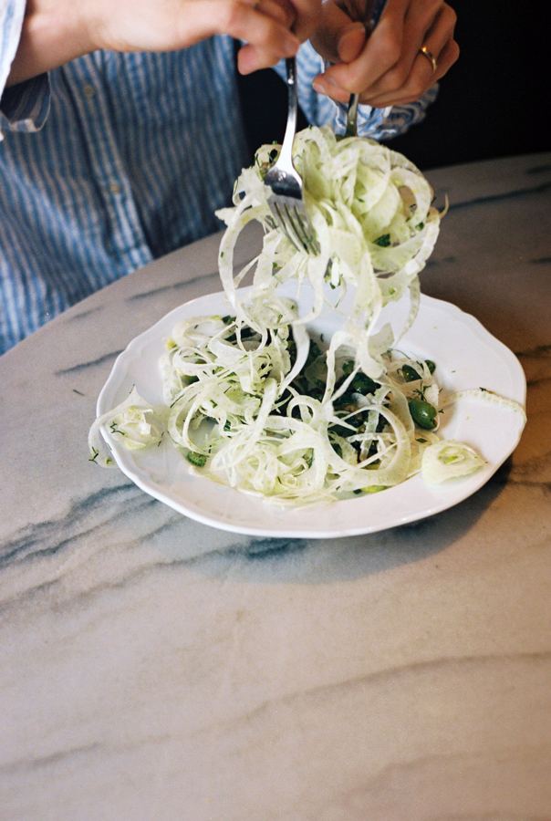 A shaved fennel salad being twirled on a marble table at Altro Paradiso on Spring Street