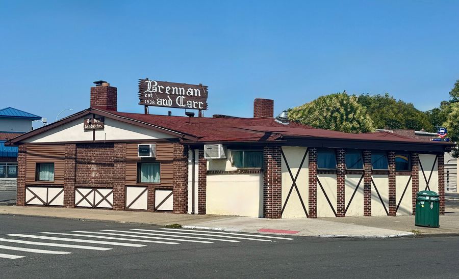 Brennan & Carr's Tudor-style brick roadhouse on Nostrand Avenue in Sheepshead Bay, under a blue sky