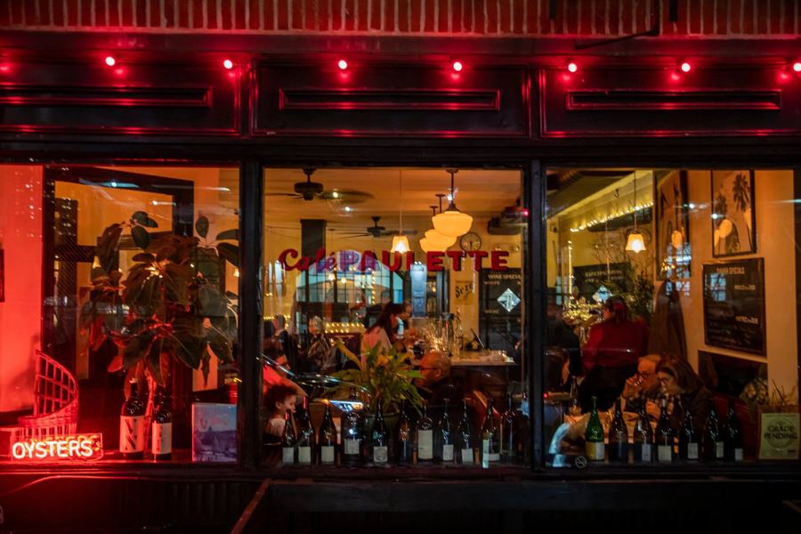 Café Paulette's red-lit windows at night on South Elliott Place in Fort Greene