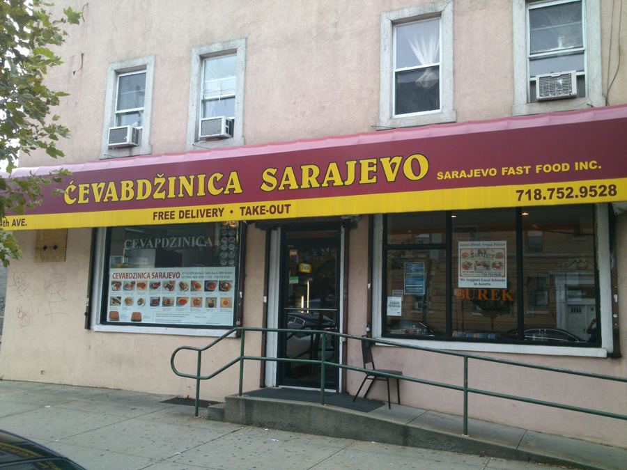 The storefront of Ćevabdžinica Sarajevo in Astoria, Queens, with its maroon-and-yellow awning reading 'Ćevabdžinica Sarajevo, Sarajevo Fast Food Inc.'
