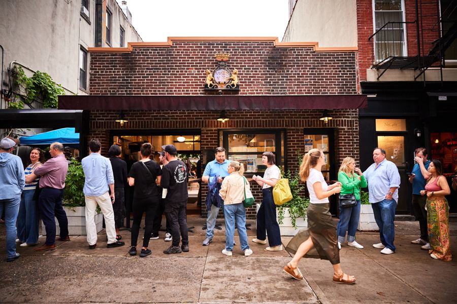 A crowd outside F&F Pizzeria's brick slice shop on Court Street