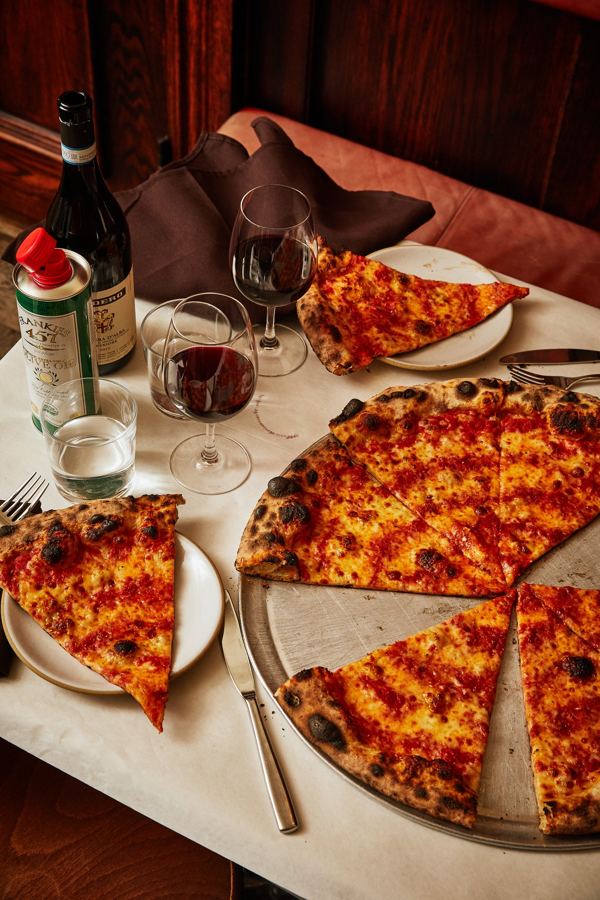 A pie with wine at a white-tablecloth table