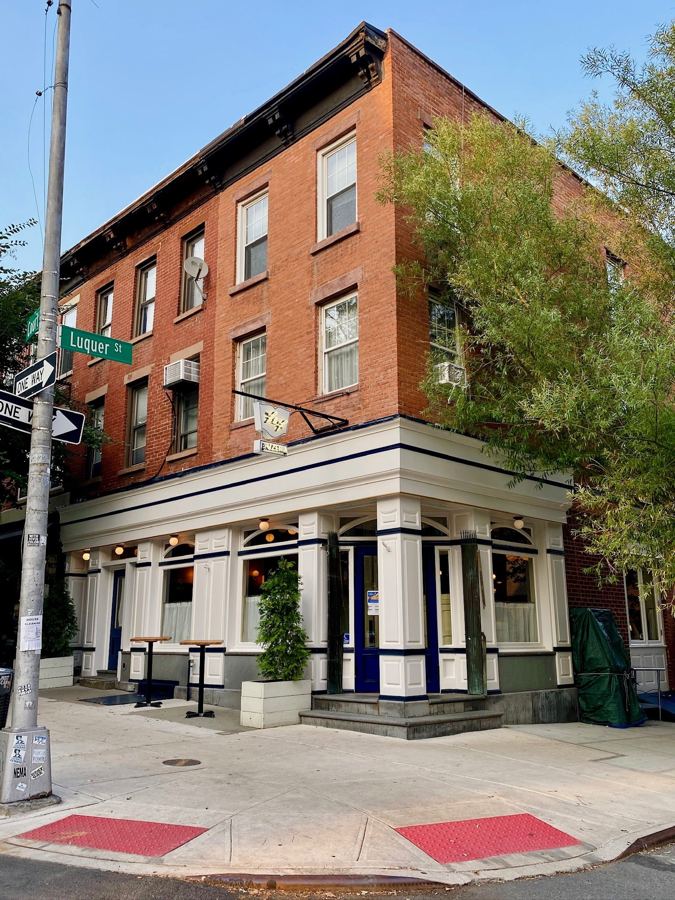 F&F Restaurant & Bar's corner storefront on Court Street, with white columns and navy trim