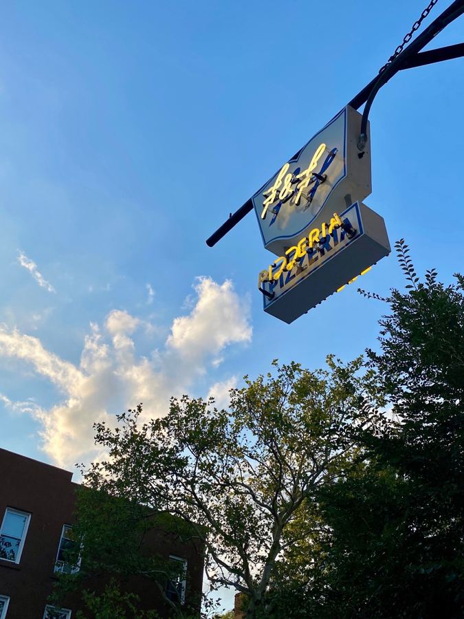 The F&F sign hanging over Court Street against a blue sky