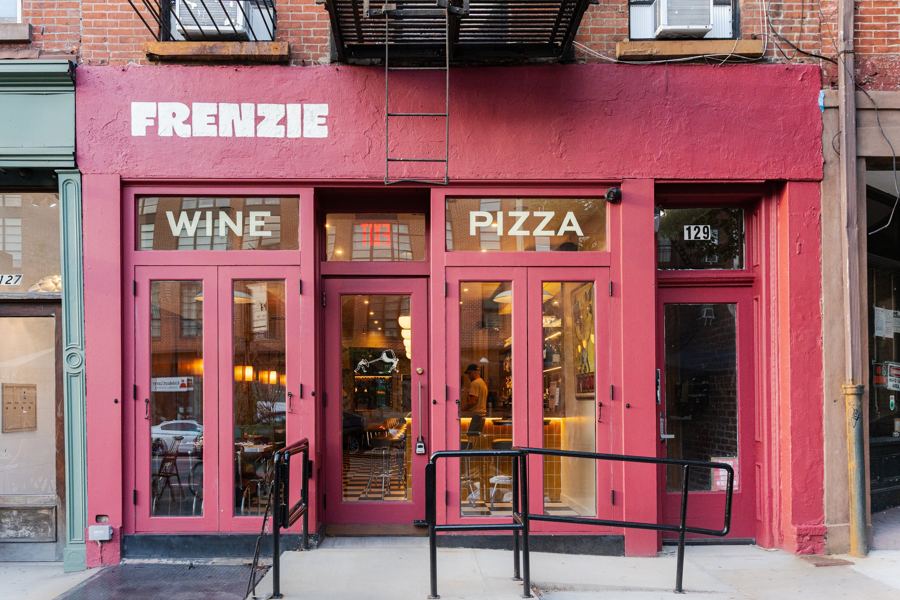 Frenzie's hot-pink storefront with 'Wine' and 'Pizza' painted over the doors