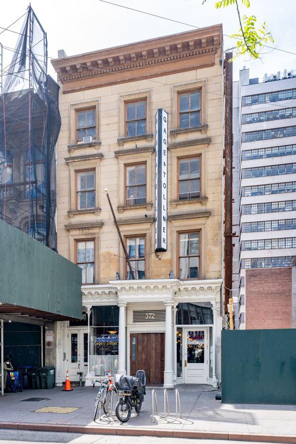 The landmark Italianate facade of Gage & Tollner at 372 Fulton Street in Downtown Brooklyn, with its vertical 'Gage & Tollner' blade sign and white cast-iron storefront