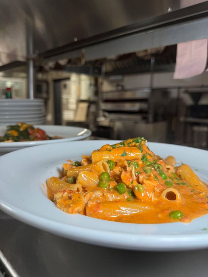 A plate of penne with peas in a creamy tomato sauce at Gino's