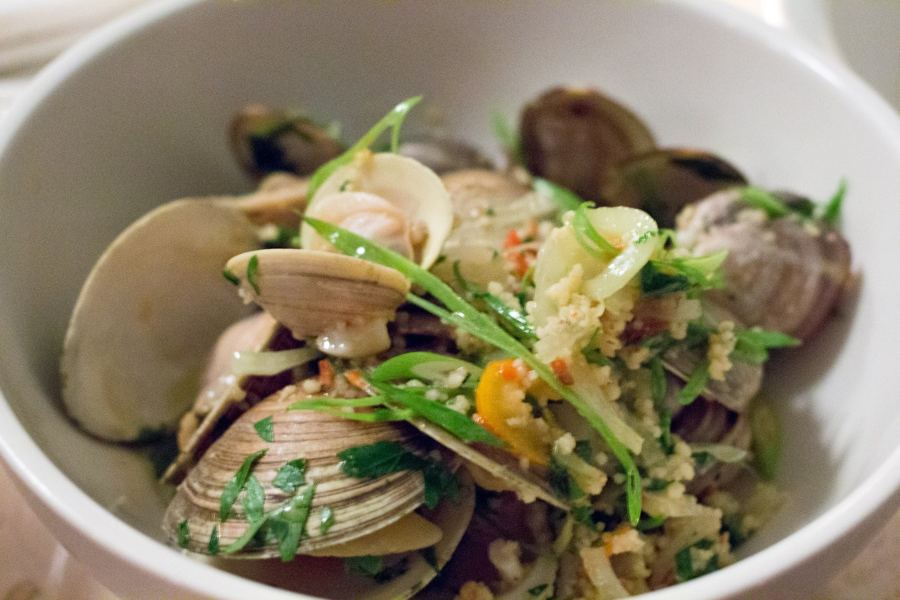 A bowl of clams with harissa and couscous served at Glasserie in Greenpoint