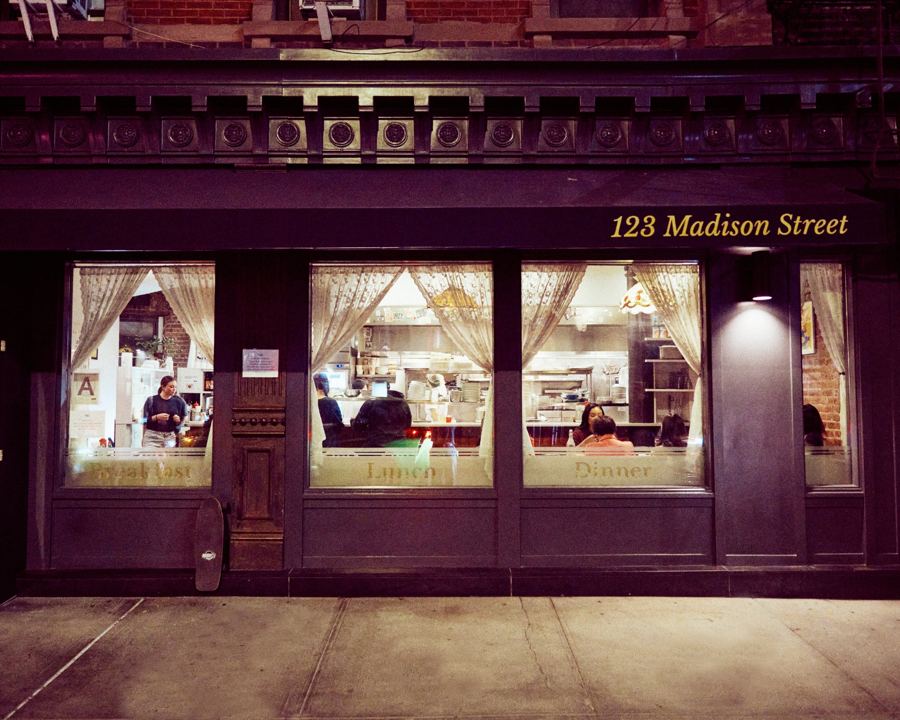 Golden Diner's storefront at 123 Madison Street at night, its windows glowing under the cornice