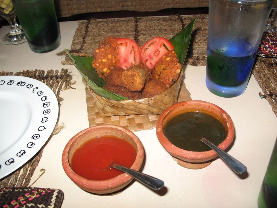 Sri Lankan dishes with red and green sambols on the table at Lakruwana on Bay Street