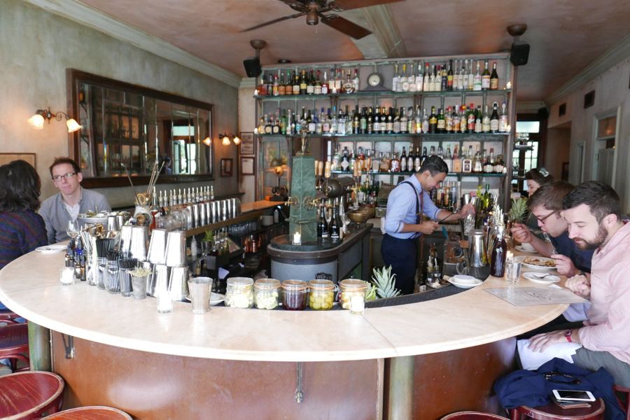 The marble horseshoe oyster bar and back-bar shelves inside Maison Premiere in Williamsburg