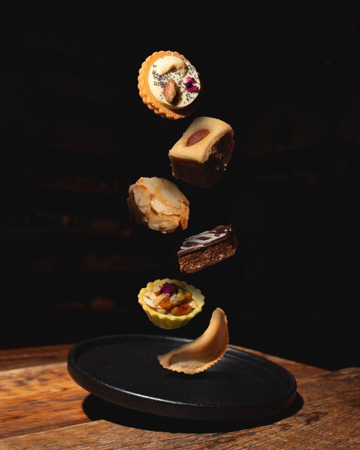Moroccan cookies and pastries falling onto a plate at Mottley Kitchen