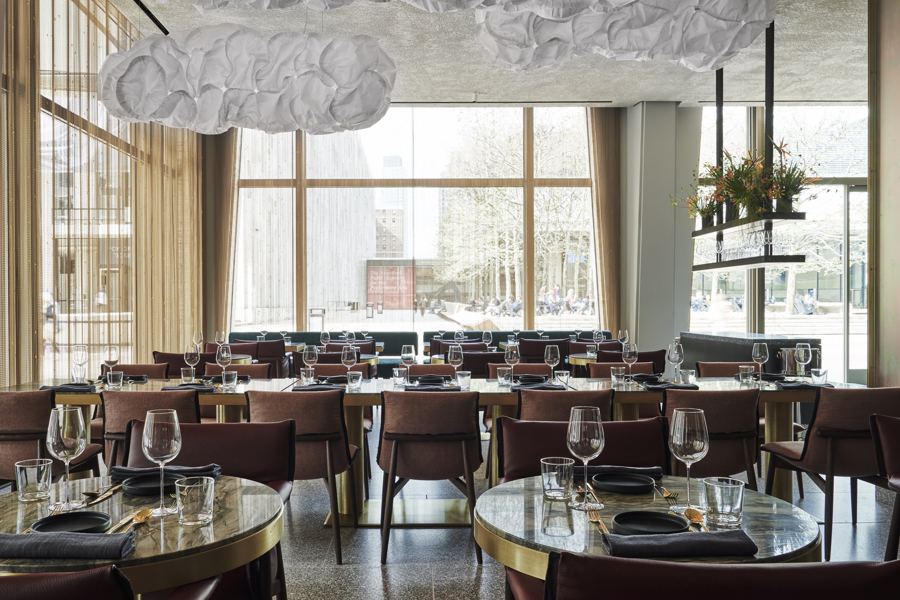 Tatiana's dining room at David Geffen Hall, under cloud-like ceiling sculptures, with tall windows onto Lincoln Center