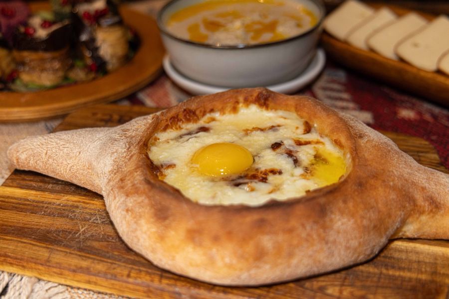 Adjaruli khachapuri with a bright egg yolk in molten cheese at Toné Café