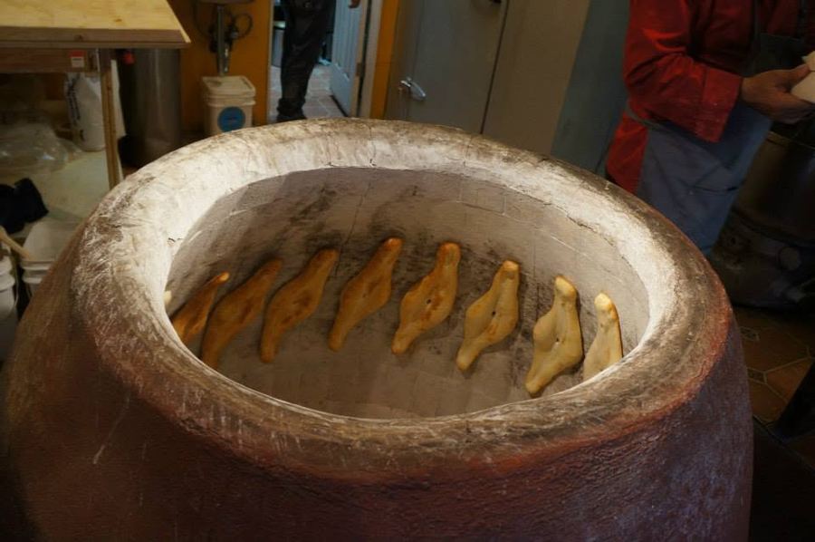 Puri loaves baking on the walls of the clay toné oven that gives Toné Café its name
