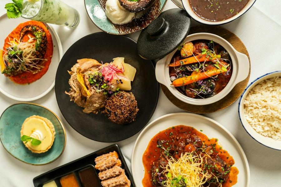 A spread of Cuban dishes at Victor's Café — stews, rice, plantains and croquetas seen from above