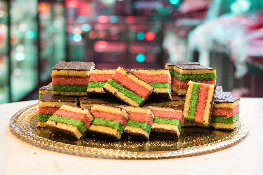 Italian rainbow cookies stacked on a gold tray at Villabate Alba