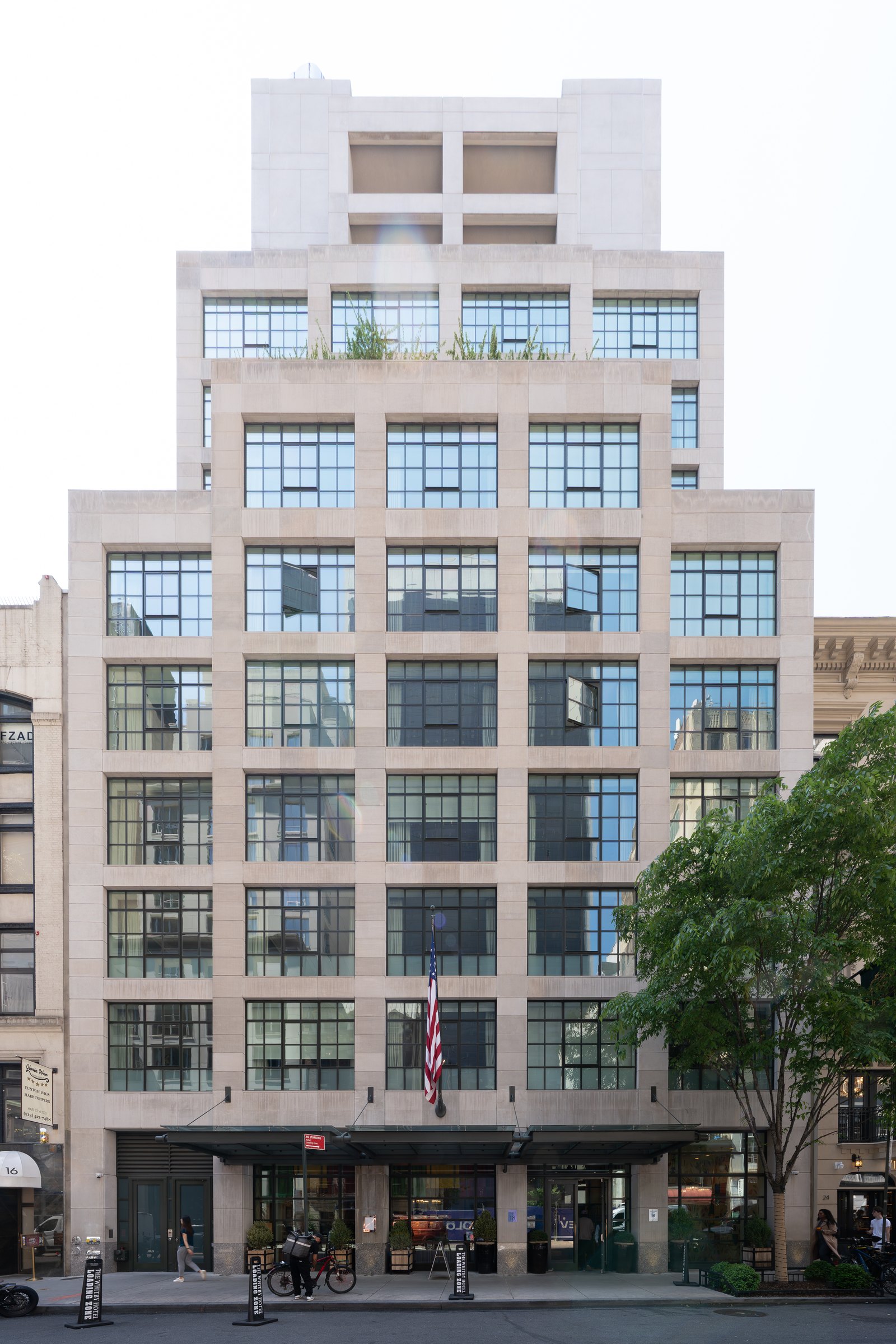 The Whitby Hotel's pale stone and glass facade on West 56th Street in Midtown