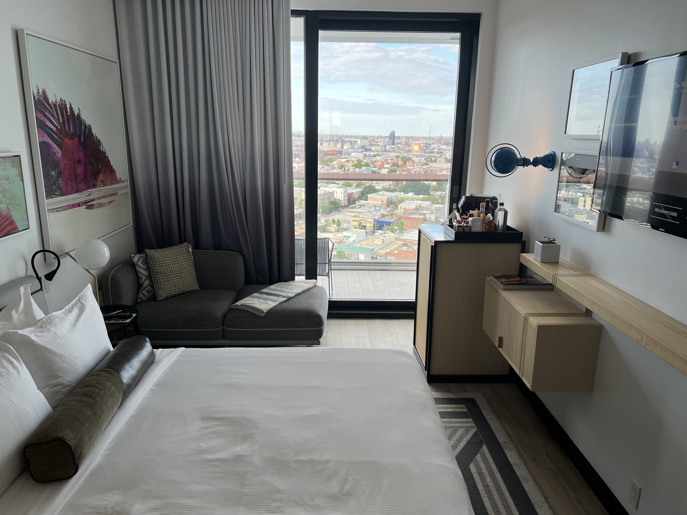 A guest room at The William Vale with a balcony view over Williamsburg