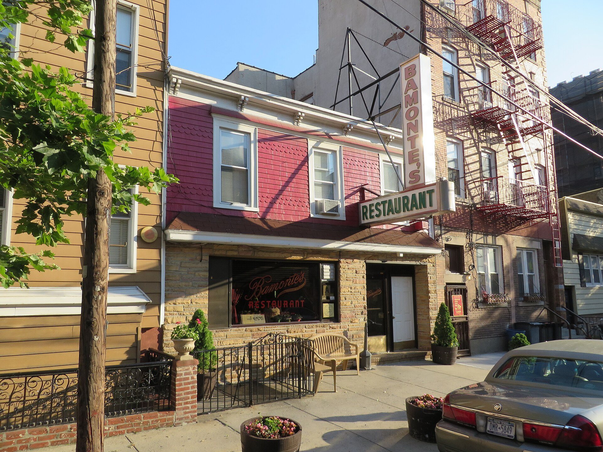 The red-shingled facade and vertical Bamonte's Restaurant sign on Withers Street in Williamsburg, Brooklyn