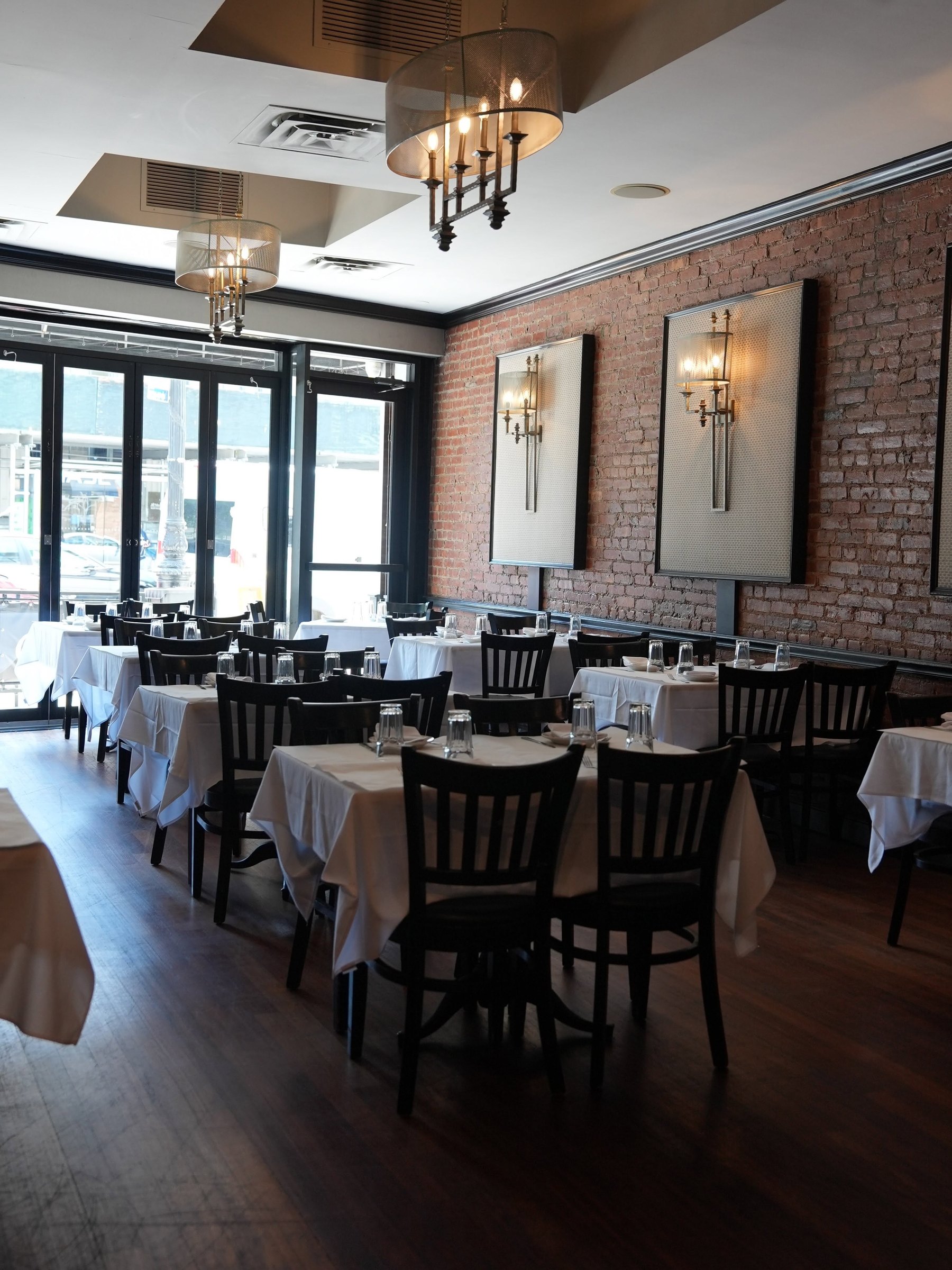 Gino's dining room on Fifth Avenue in Bay Ridge, white tablecloths, brick and framed mirrors