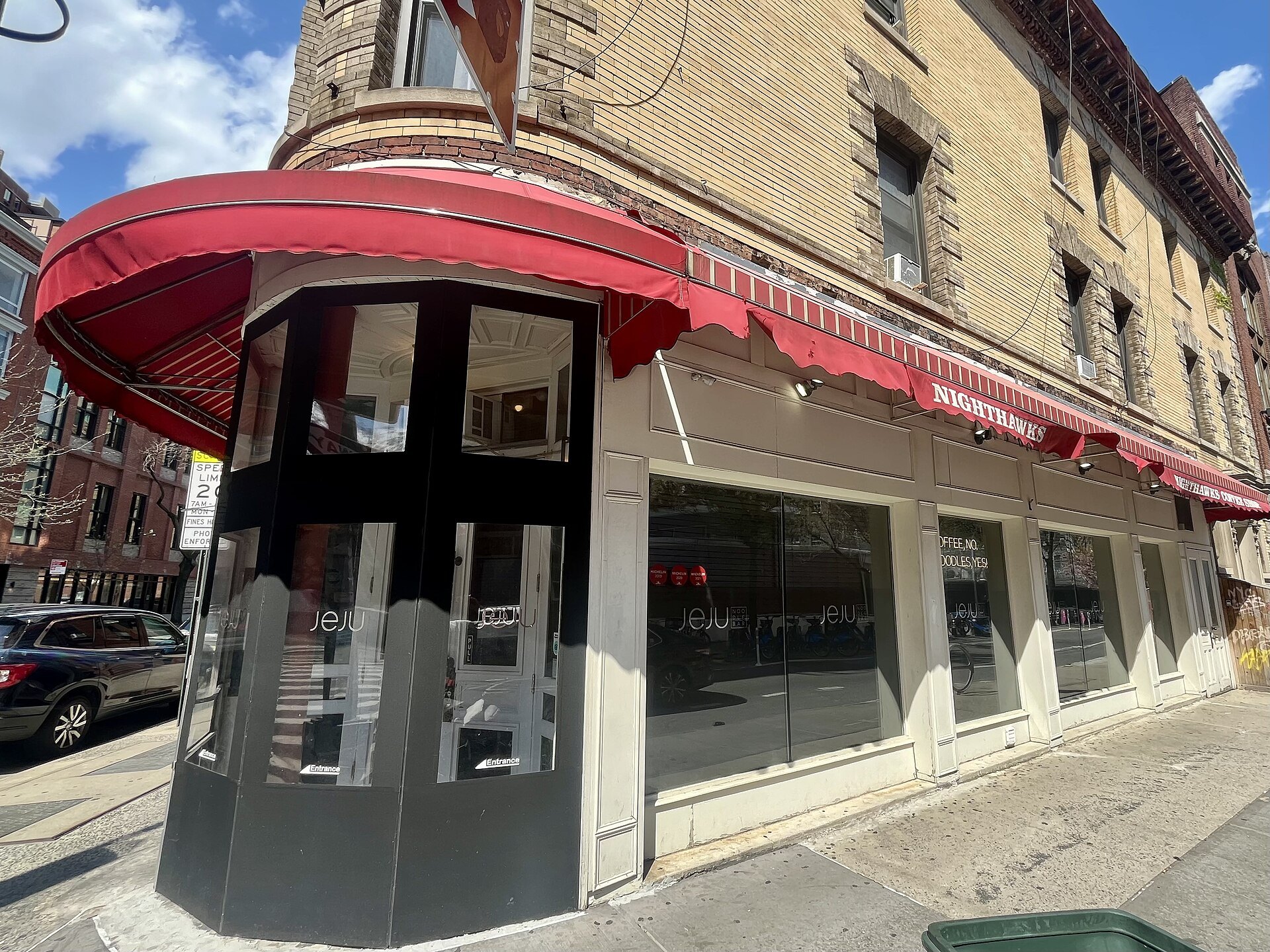 Jeju Noodle Bar's red-awninged corner at 679 Greenwich Street in the West Village