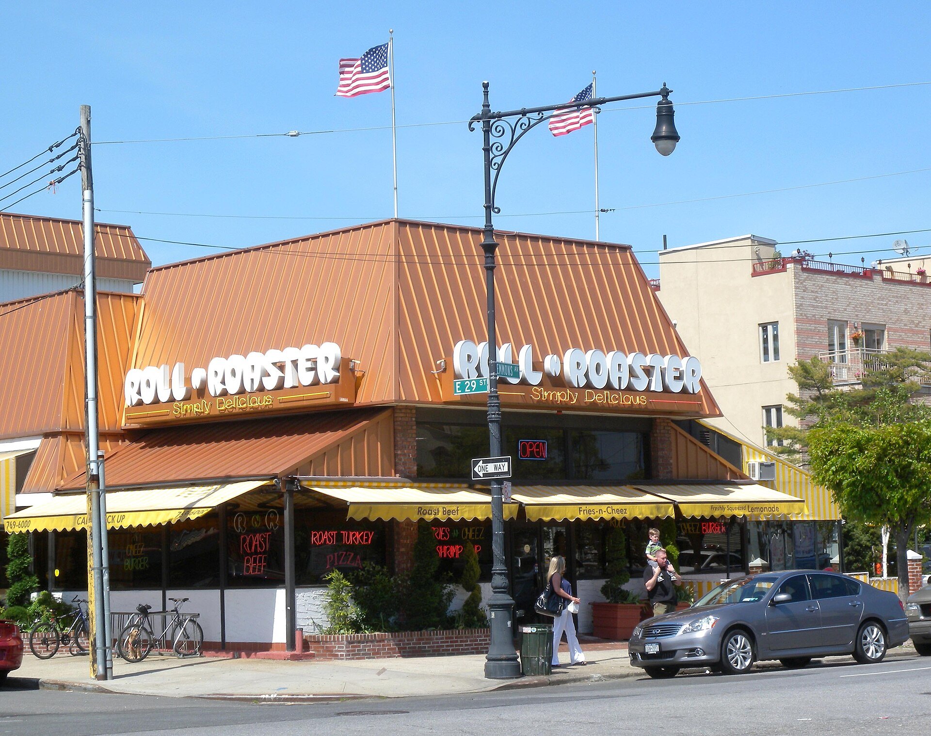 Roll-N-Roaster's orange-roofed restaurant on Emmons Avenue in Sheepshead Bay, flags flying above