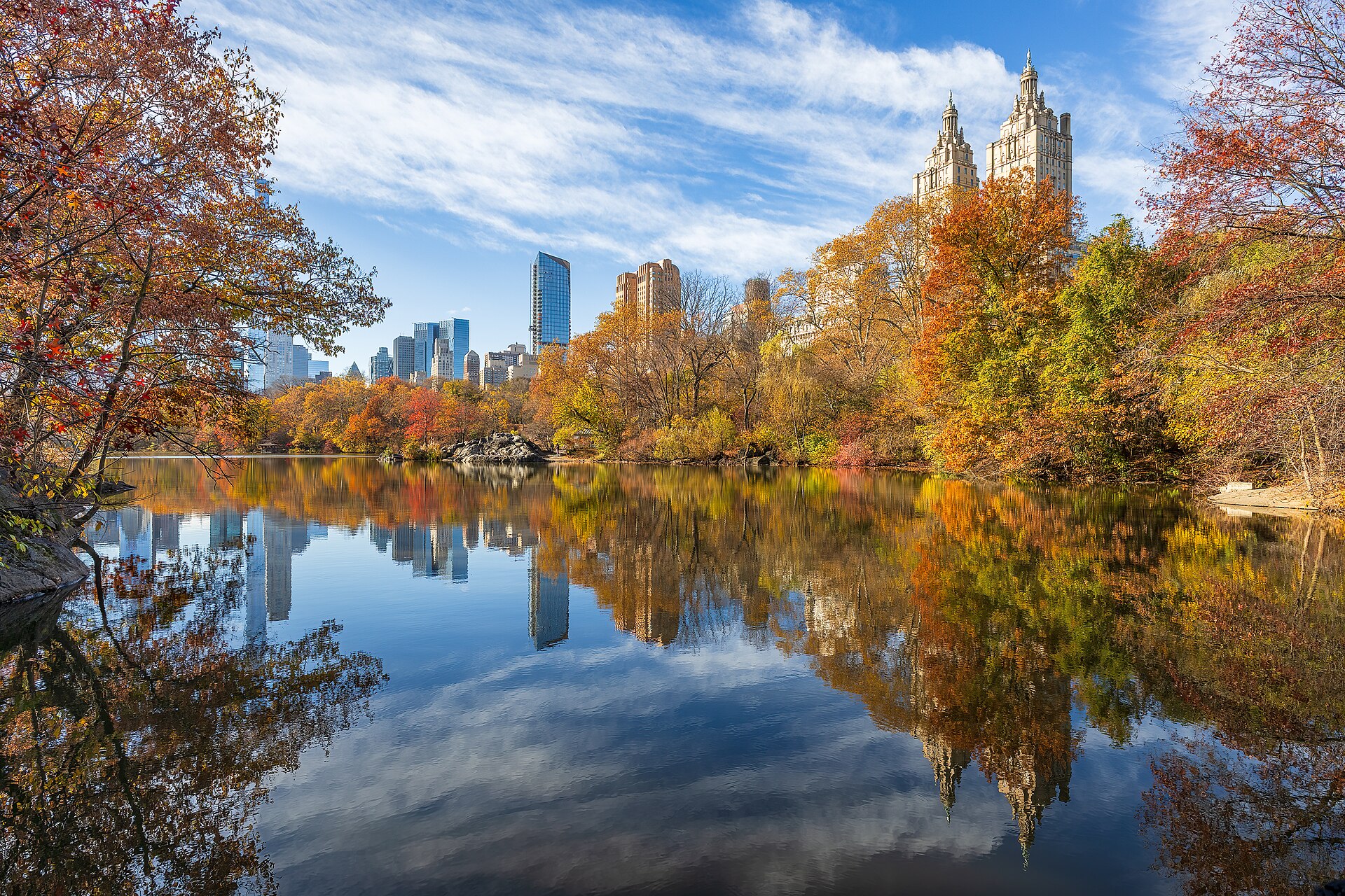 Peak autumn color around the Lake in Central Park, with the twin towers of the San Remo reflected in the water