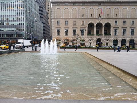 The fountain pool on the granite plaza of the Seagram Building, looking across Park Avenue